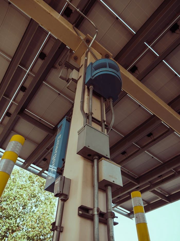 Vertical view of solar panel installation on a parking structure pillar showcasing renewable energy technology.